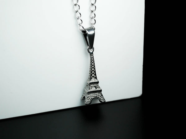 Eiffel Tower necklace momento against white background Stock Photo - Alamy